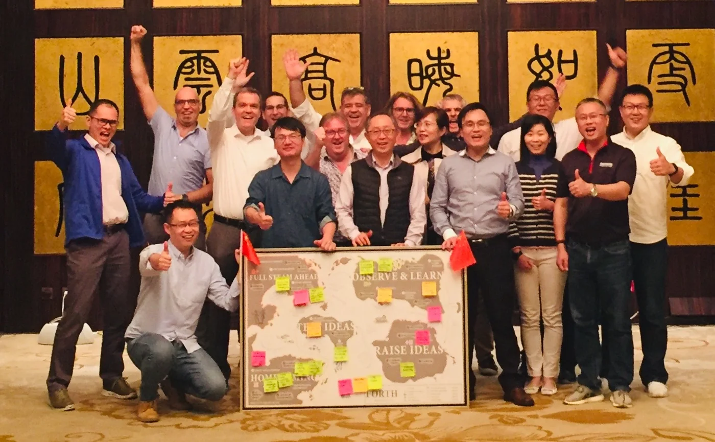 A Huntsman FORTH innovation team celebrating around their completed FORTH Innovation Map